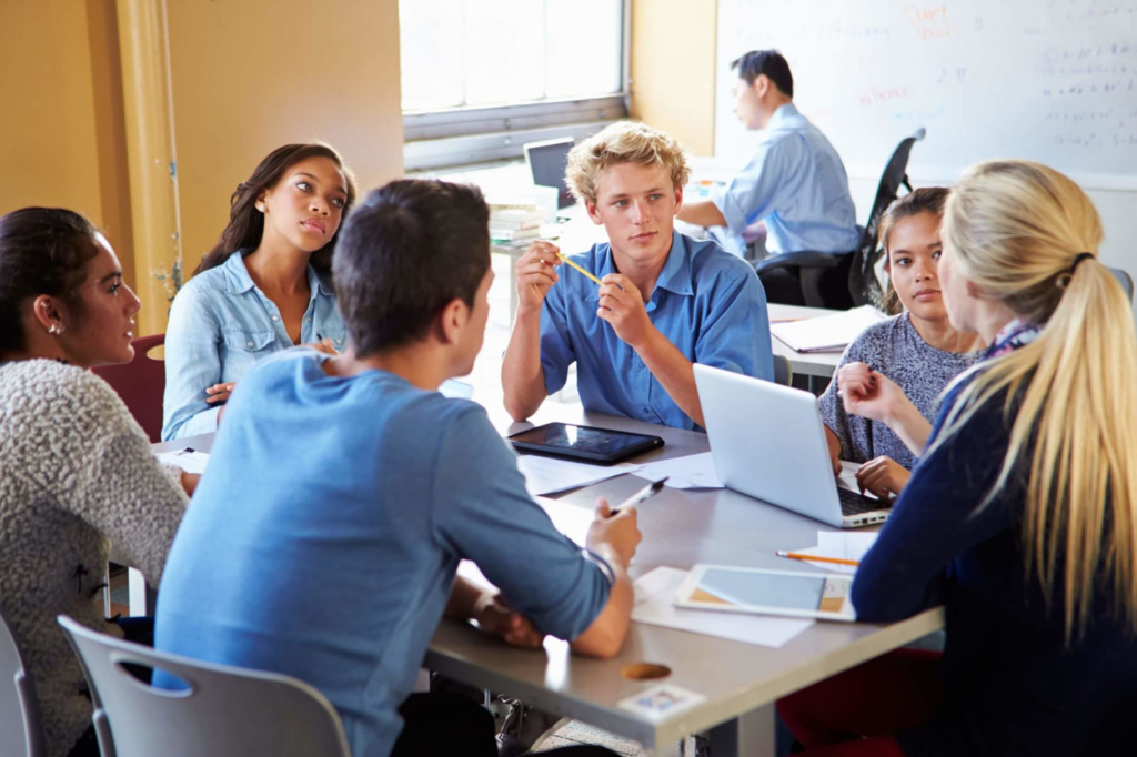 A group of college students working together in a classroom.